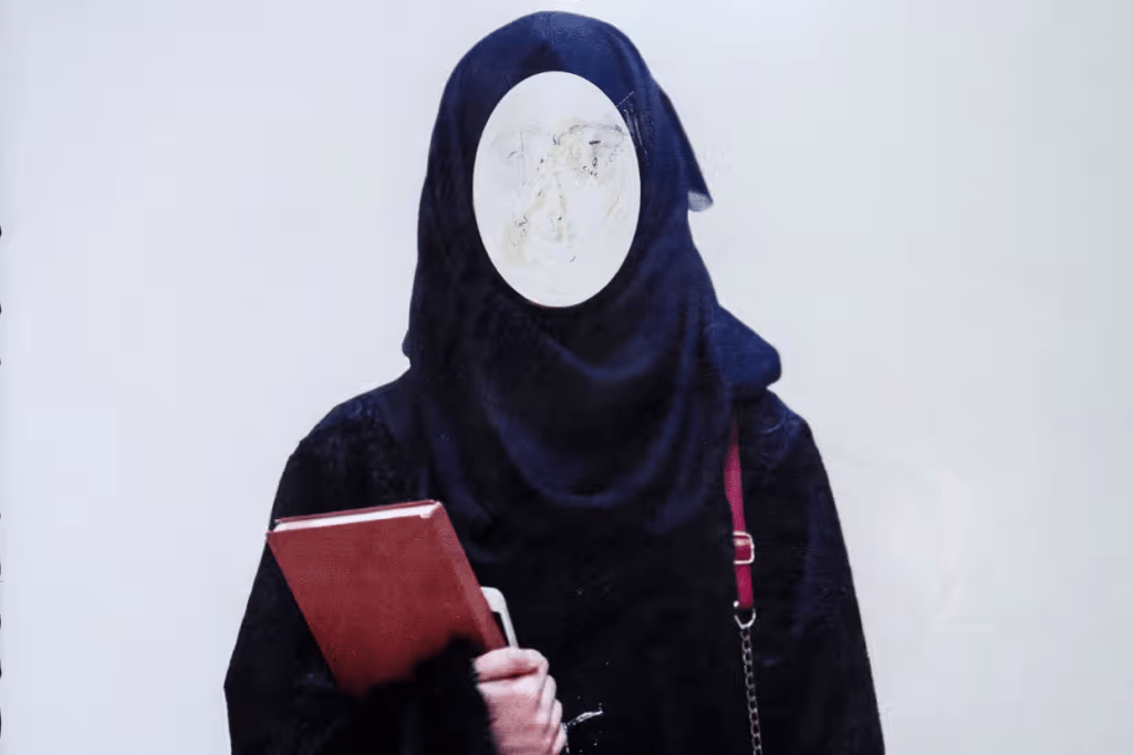 A poster ordering women to wear the hijab at a private university in Afghanistan. The Taliban then barred women from universities in 2022.